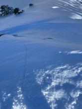 Long cracks running down several steps of this slope. 