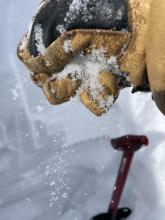 Sugary snow falling from hand