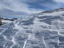 Wind scoured snow surfaces in exposed areas with dense hard wind slabs