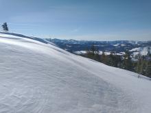 Drifting snow depositing as a hard slab on W aspect terrain.