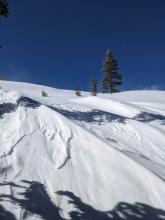 Wind-sculpted snow surfaces on the E aspects of Andesite Peak.