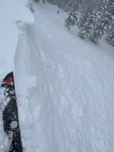 Cracking and failing wind slabs on steep terrain along the ridge. 