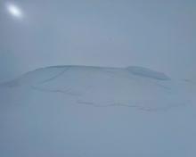 Looking up at the thin wind slab that I triggered from the ridge on the lookers left. 