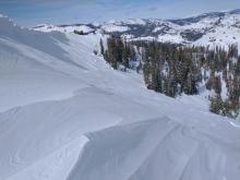 Previous scouring by NE winds on E aspect terrain above treeline. A few roller balls visible off of the trees.