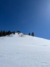 Looking up this shoulder, the snow was fairly scoured with exposed rocks and firm snow.