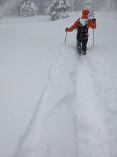 Deep trail breaking with minor storm slab cracking on the skin track edges.