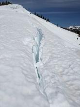 Large crevasse-like cracks exist where cornices are pulling away from the ridges. 