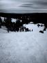 The confluence of debris where the skier was found. The person is standing next to the burial location.