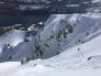 Skier descending onto slope before avalanche.