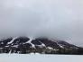 Looking across Red Lake at Red Lake Peak obscured by clouds.